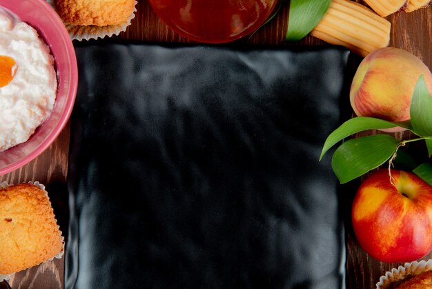 Close-up view of peach peach jam cupcake cottage cheese with plate on center on wooden table