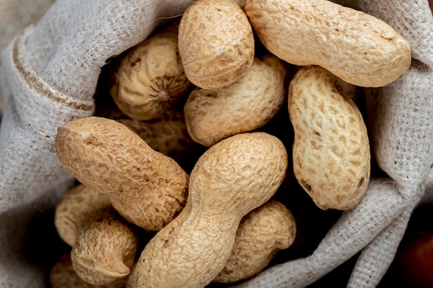 Close up view of peanuts in shell in a sack