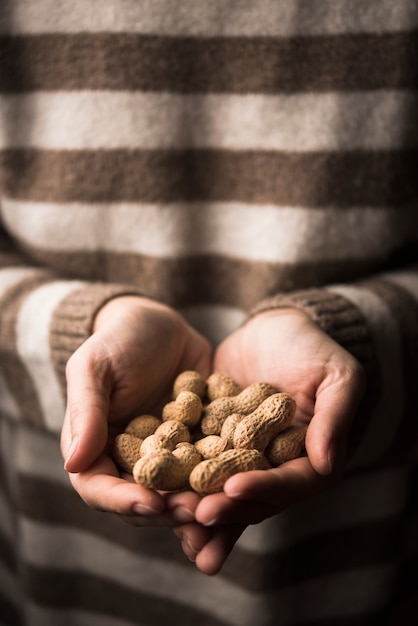Close-up view of peanuts in woman hands