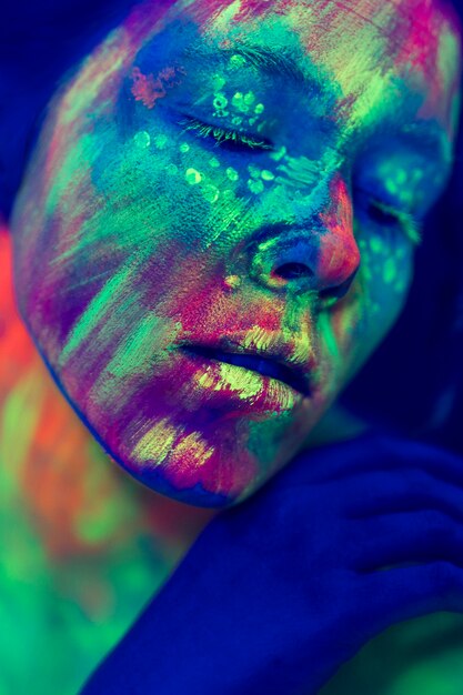 Close-up view of person with fluorescent make-up