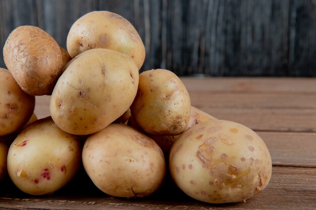 Close up view of potatoes on wooden surface and background with copy space 2