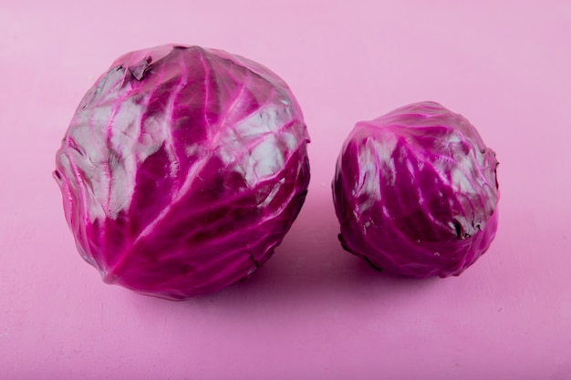 Close-up view of purple cabbages on purple background with copy space