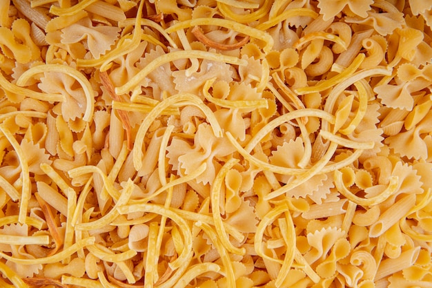 Close up view of raw pasta of different shapes and types
