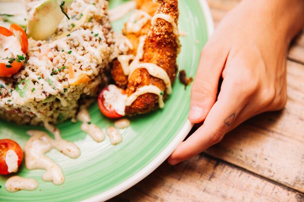 Close up view of rice dish and hands