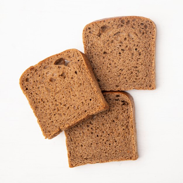 Close-up view of rye bread slices on white background with copy space