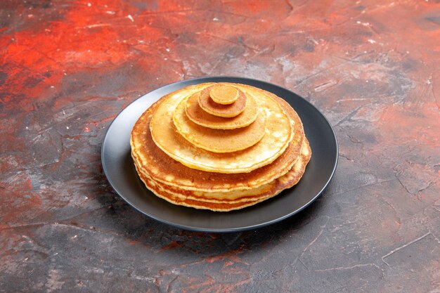 Close up view of simple homemade pancakes in a black plate