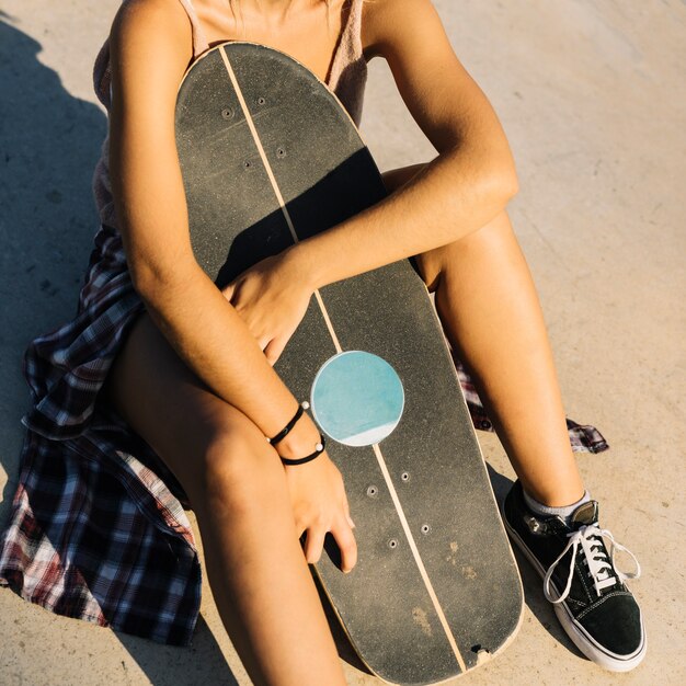 Close up view of skater girl holding board