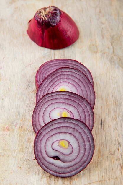 Close-up view of sliced red onion on wooden background