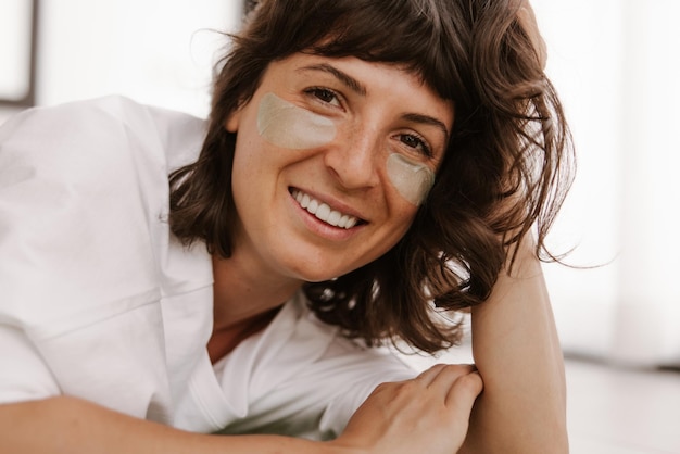 Close up view of smile woman with patches look at camera