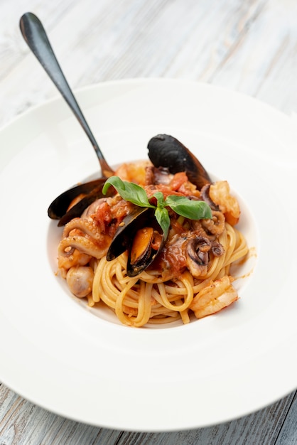 Close-up view of spaghetti on wooden table