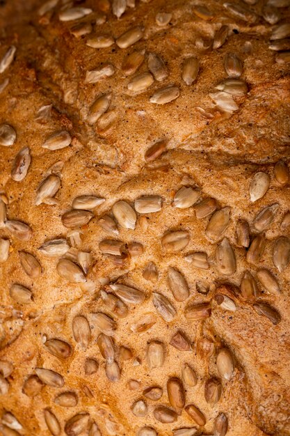 Close-up view of sunflower seeds on cob bread as background