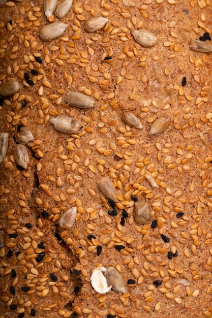 Close-up view of sunflower seeds and poppy seeds on sandwich bread as background