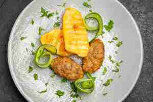 Free photo close up view of tasty dinner with cutlet meal potatoes on a white plate on dark table