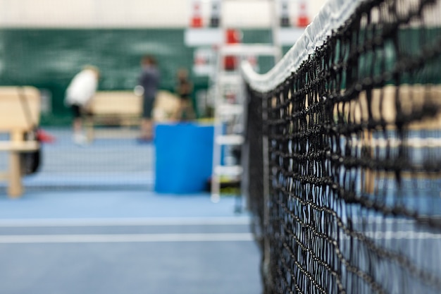 Close up view of tennis court through the net