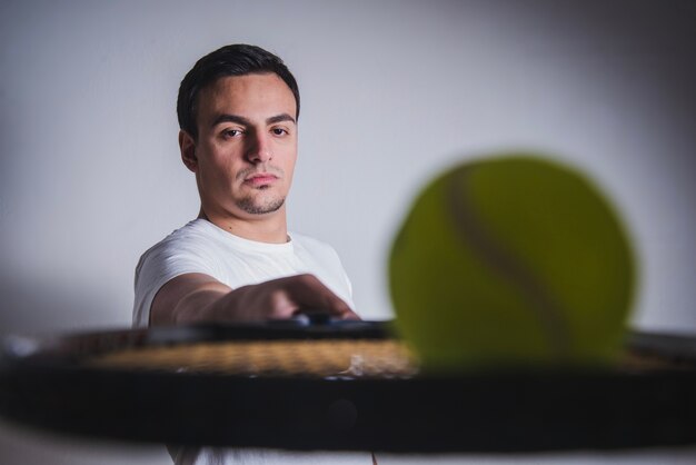 Close up view tennis player with racket and ball