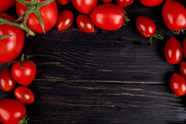 Close-up view of tomatoes on wooden table with copy space