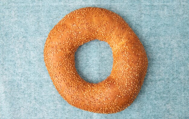 Close-up view of turkish sesame bread on blue background with copy space