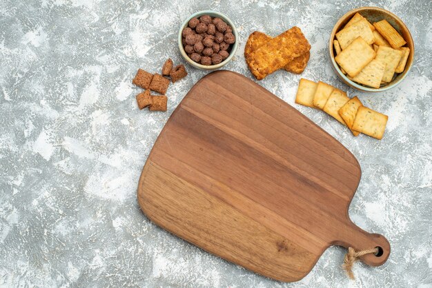 Close up view of various cookies with biscuits and cutting board on blue