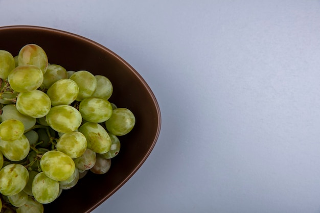 Close-up view of white grape in bowl on gray background with copy space