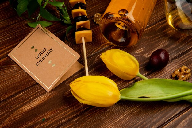 close-up view of white wine with cheddar cheese and walnut grape good everyday card and flowers on wooden table