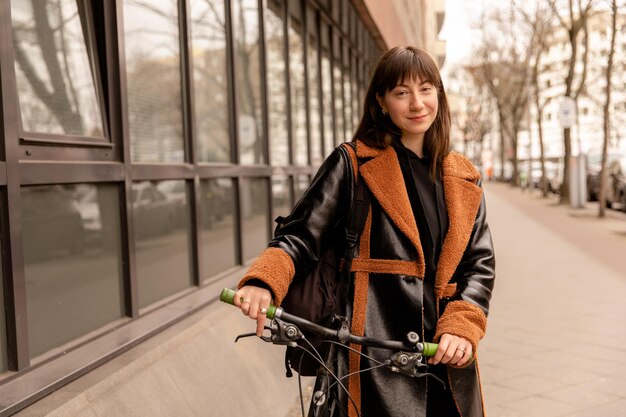 Close up view of woman with bike looking at camera