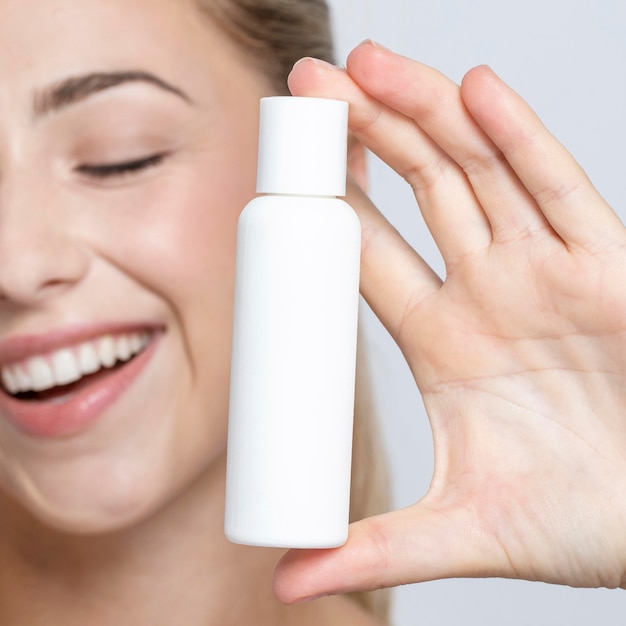 Close-up view of woman with bottle