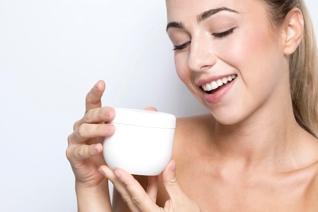 Free photo close-up view of woman with cream with copy space