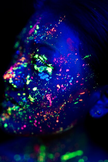 Close-up view of woman with fluorescent make-up