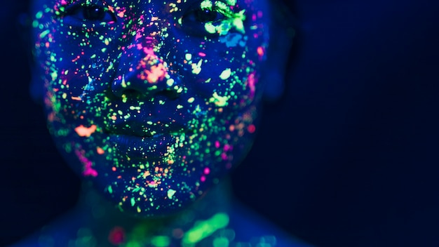 Close-up view of woman with fluorescent make-up