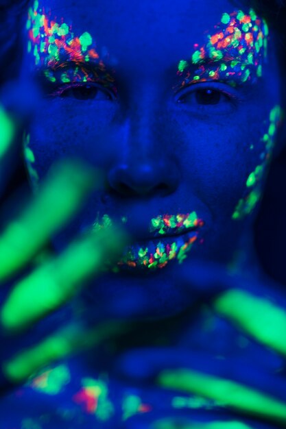 Close-up view of woman with fluorescent make-up