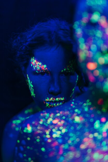 Close-up view of woman with fluorescent make-up