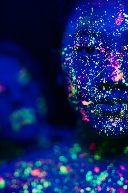 Close-up view of woman with fluorescent make-up