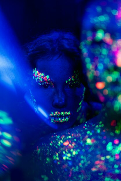 Close-up view of woman with fluorescent make-up