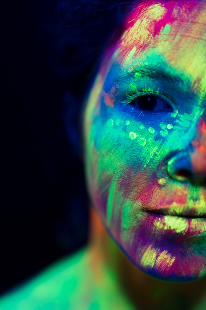 Close-up view of woman with fluorescent make-up