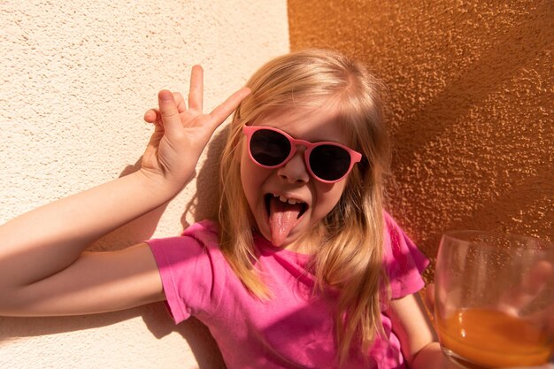 Close up view of young girl sitting at home and having fun