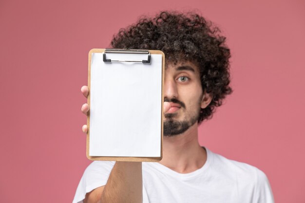 Close up view young man showing his office notebook to camera