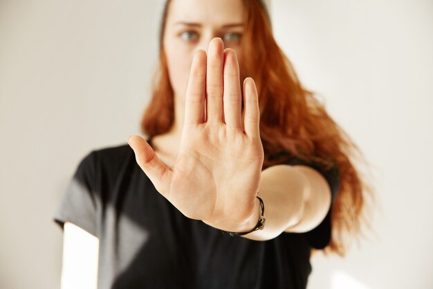 close up view of young woman making stop gesture with her hand