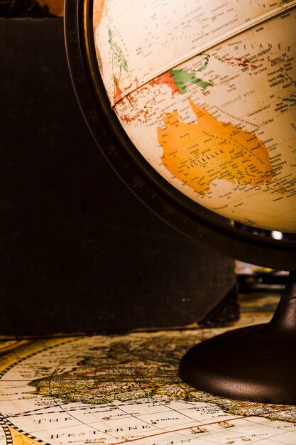 Close-up of a vintage globe on map