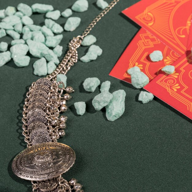 Close up vintage necklace next to tarot cards