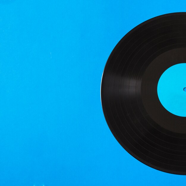 Close-up of vinyl record on blue background