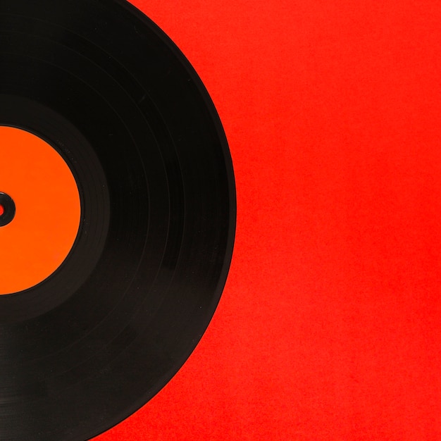 Close-up of vinyl record over the red background