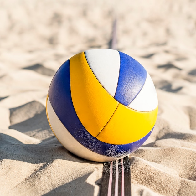 Close-up of volleyball on the beach sand