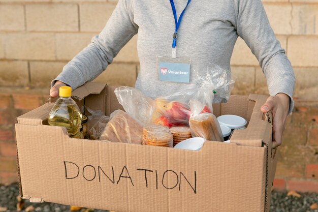 Close up volunteer holding box with food