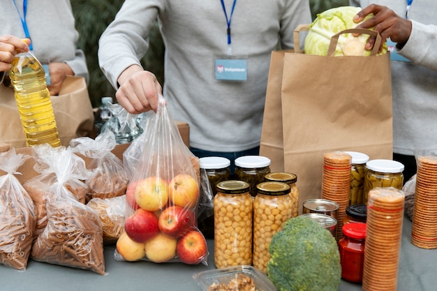 Close up volunteers collecting food