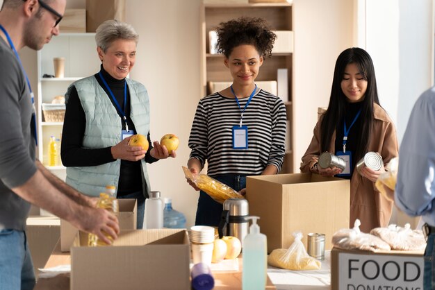 Close up volunteers with food donations