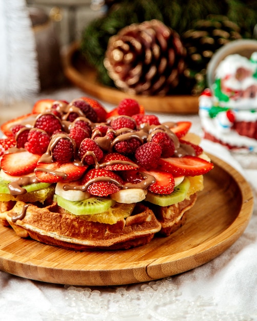 Close up of waffle with fruits garnished with chocolate