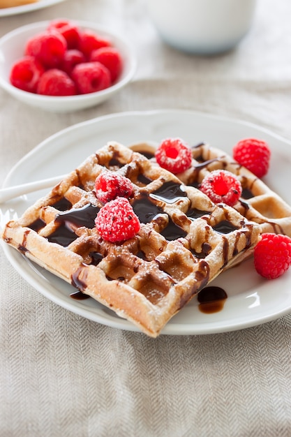 Close-up of waffles with chocolate and raspberries