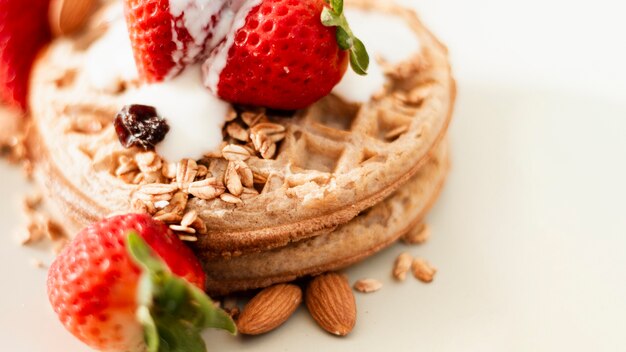Close up waffles with strawberries oats and yogurt