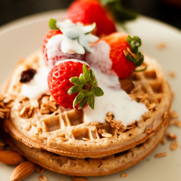 Close up waffles with strawberries and yogurt
