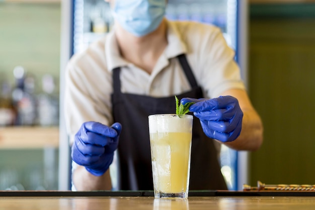 Free photo close-up waiter with gloves and mask